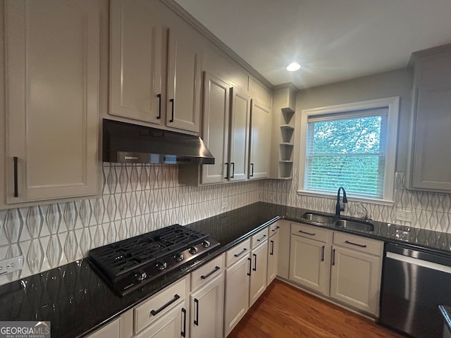 kitchen featuring decorative backsplash, sink, black gas cooktop, dishwasher, and dark hardwood / wood-style floors