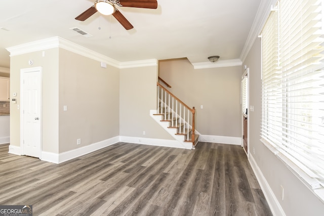 unfurnished living room with crown molding, ceiling fan, and dark wood-type flooring