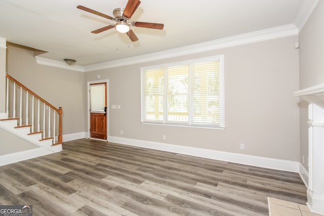 unfurnished living room featuring ceiling fan, wood-type flooring, and ornamental molding