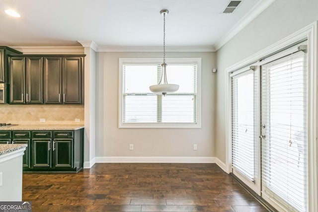 unfurnished dining area with dark hardwood / wood-style floors and crown molding