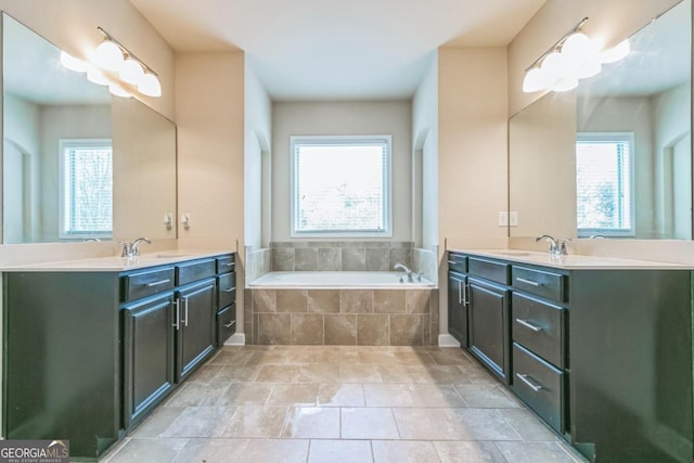 bathroom featuring vanity and tiled bath