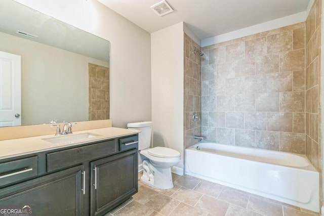 full bathroom with tiled shower / bath combo, toilet, and vanity