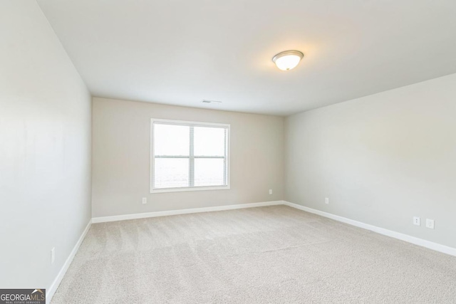 spare room with light carpet