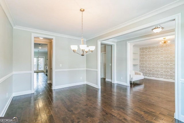 unfurnished dining area featuring dark hardwood / wood-style floors, an inviting chandelier, and crown molding