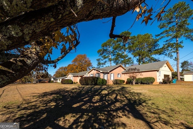 ranch-style house with a front lawn