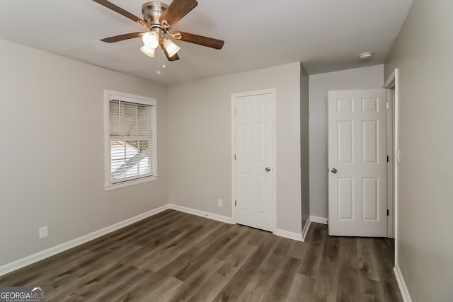 unfurnished bedroom with dark hardwood / wood-style floors and ceiling fan