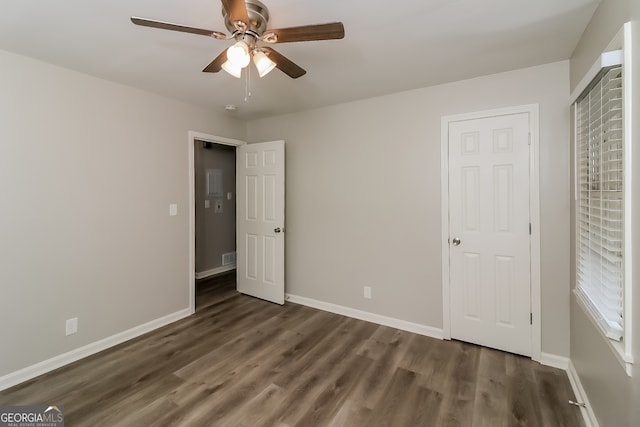 unfurnished bedroom with dark hardwood / wood-style floors and ceiling fan