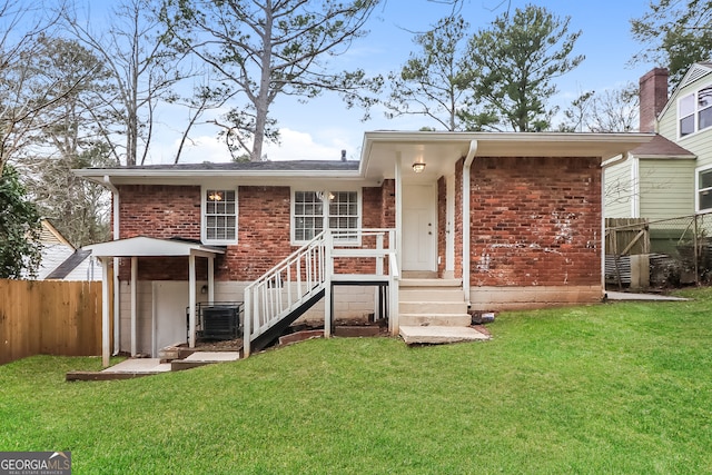 rear view of property with central AC unit and a lawn