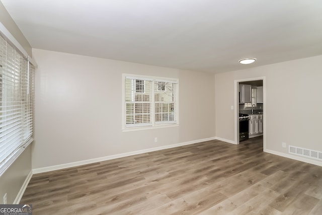 spare room with hardwood / wood-style floors