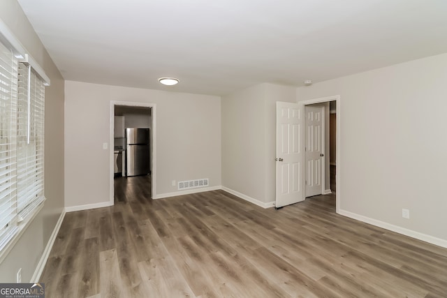 unfurnished room featuring hardwood / wood-style floors