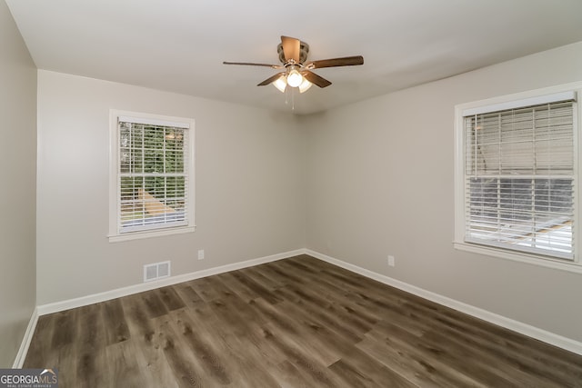 unfurnished room featuring dark hardwood / wood-style floors and ceiling fan