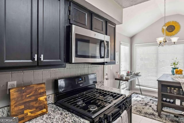 kitchen with light stone countertops, gas stove, an inviting chandelier, hanging light fixtures, and lofted ceiling