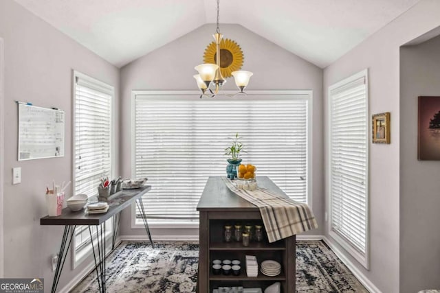 dining room with lofted ceiling and an inviting chandelier