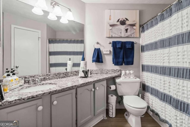 bathroom featuring hardwood / wood-style flooring, vanity, and toilet