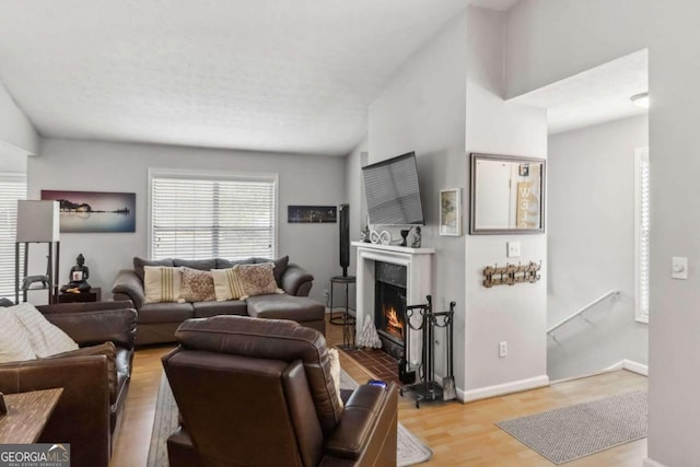 living room with lofted ceiling and light wood-type flooring