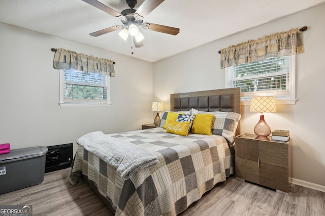 bedroom with hardwood / wood-style floors and ceiling fan