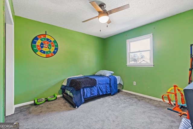 carpeted bedroom featuring a textured ceiling and ceiling fan