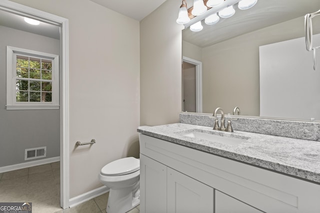 bathroom featuring tile patterned flooring, vanity, and toilet