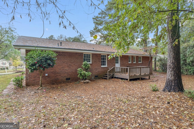 back of house featuring a deck