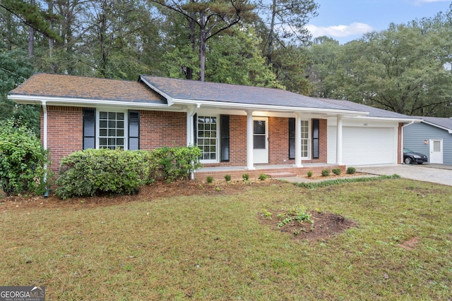 single story home with a front yard, a garage, and covered porch