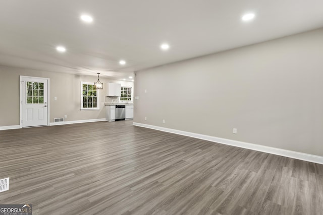 unfurnished living room with dark wood-type flooring