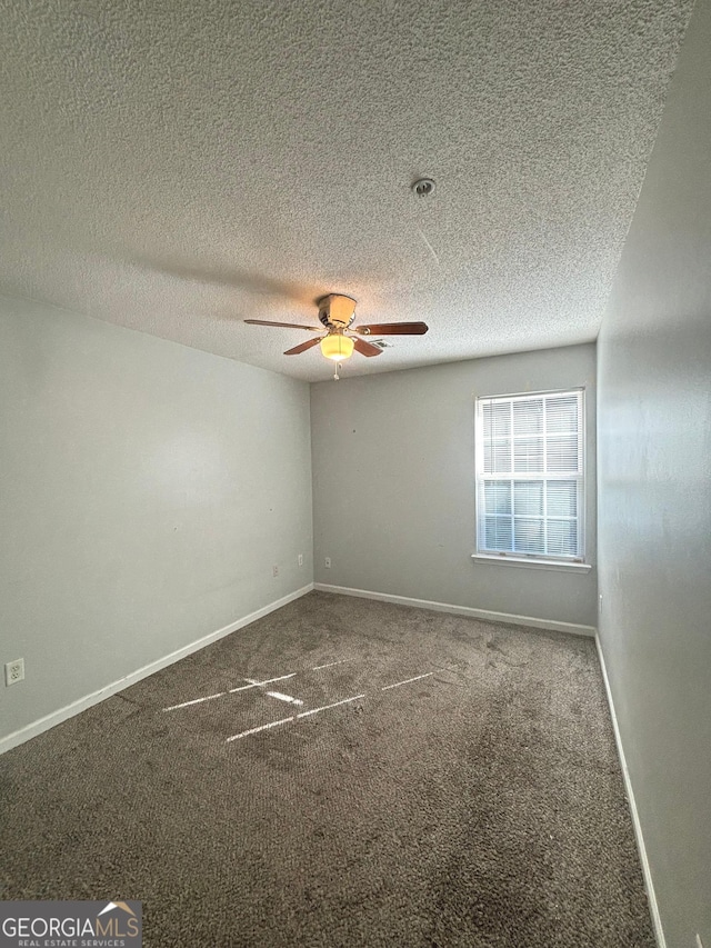 unfurnished room featuring ceiling fan, carpet, and a textured ceiling