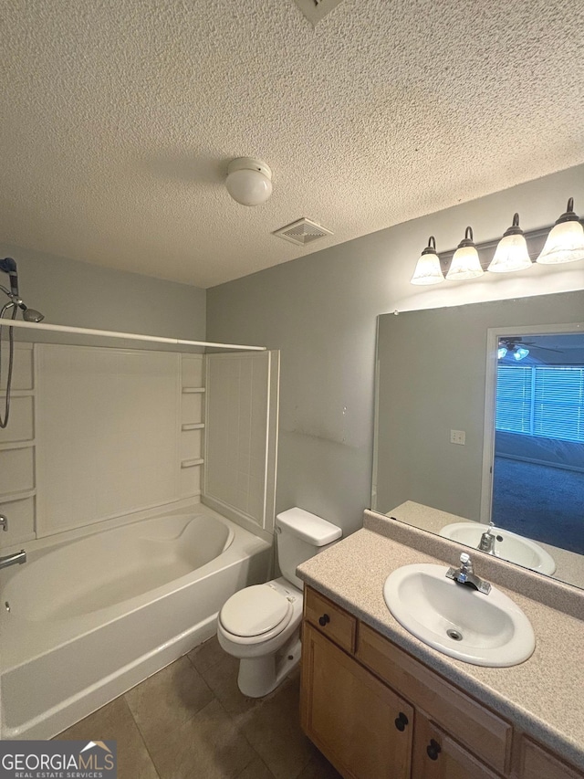 full bathroom featuring vanity, bathtub / shower combination, tile patterned flooring, toilet, and a textured ceiling