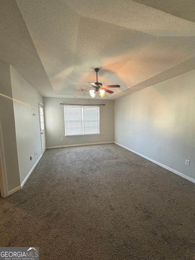 carpeted spare room featuring a textured ceiling and ceiling fan