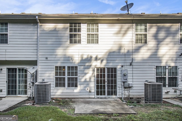 rear view of property with central AC unit and a patio area