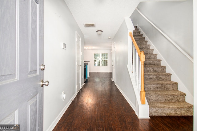 entryway featuring a textured ceiling and dark hardwood / wood-style floors