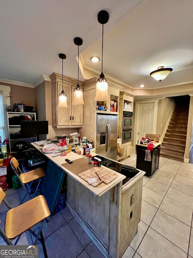 kitchen featuring pendant lighting, light brown cabinets, a kitchen breakfast bar, kitchen peninsula, and stainless steel appliances