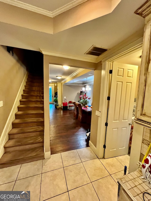 interior space featuring wood-type flooring and ornamental molding