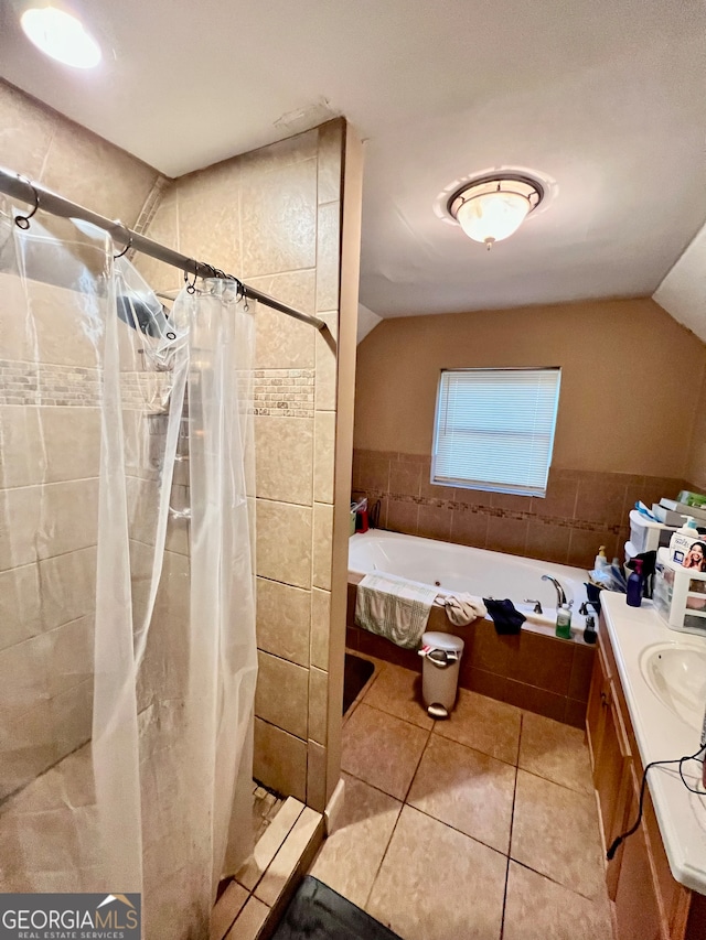 bathroom with walk in shower, tile patterned flooring, vaulted ceiling, vanity, and tile walls