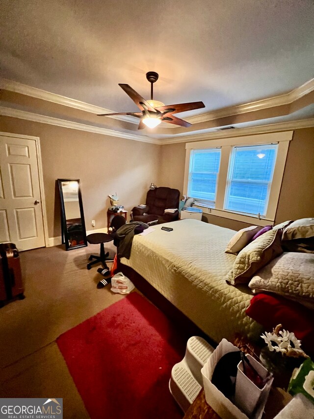 carpeted bedroom featuring ceiling fan and ornamental molding