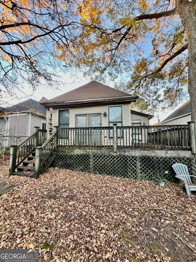 back of property featuring a wooden deck