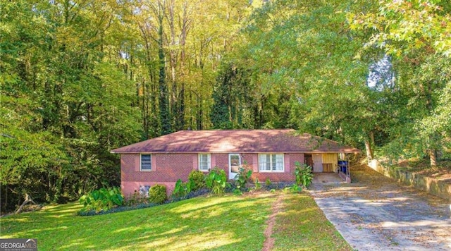 view of front of property with a front yard and a carport