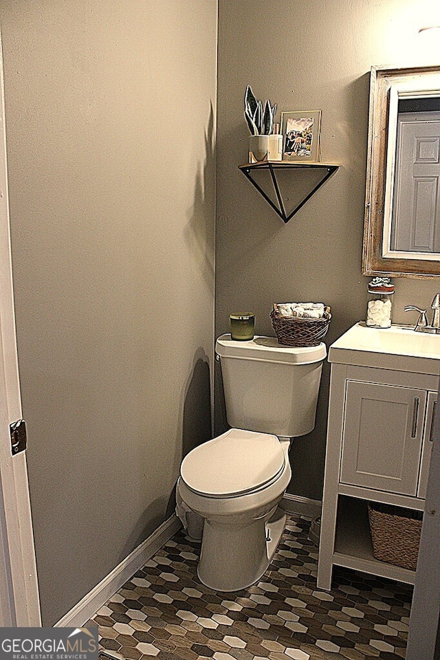 bathroom featuring vanity and toilet