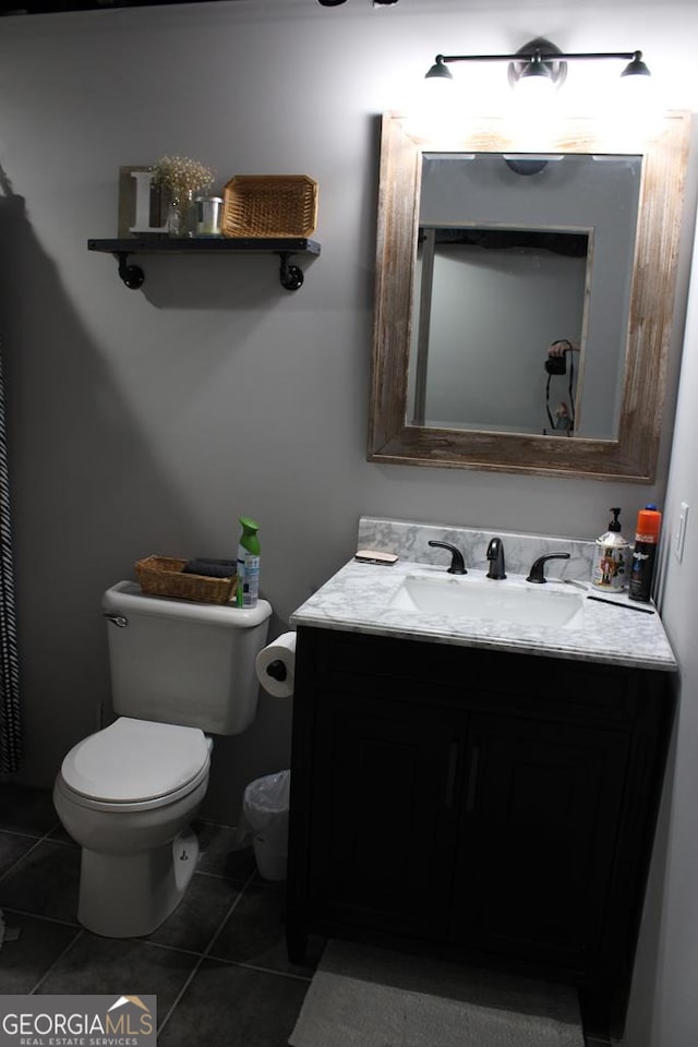 bathroom featuring tile patterned floors, vanity, and toilet