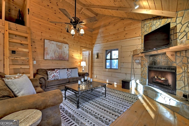 living room with beam ceiling, hardwood / wood-style flooring, wooden ceiling, a fireplace, and wood walls