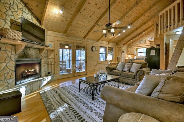 living room featuring beam ceiling, wooden ceiling, and wooden walls