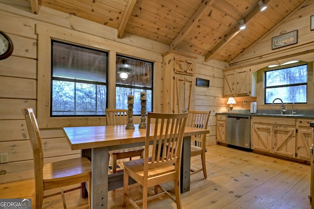 dining room featuring track lighting, wood walls, wood ceiling, and light hardwood / wood-style flooring