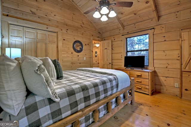 bedroom featuring wood ceiling and wood walls