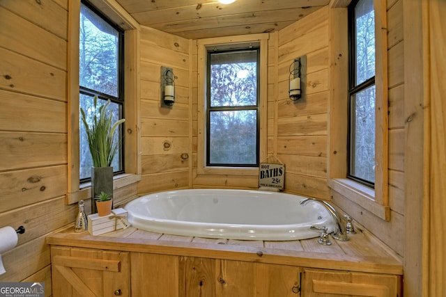 bathroom with a healthy amount of sunlight, wooden walls, and wooden ceiling