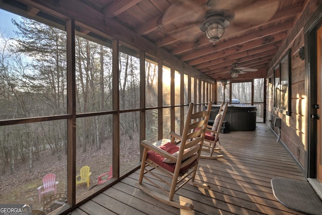 sunroom with lofted ceiling with beams, ceiling fan, and wood ceiling