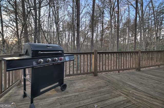 wooden terrace featuring a grill