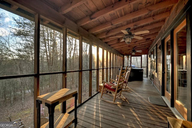 unfurnished sunroom with beam ceiling, ceiling fan, and wooden ceiling