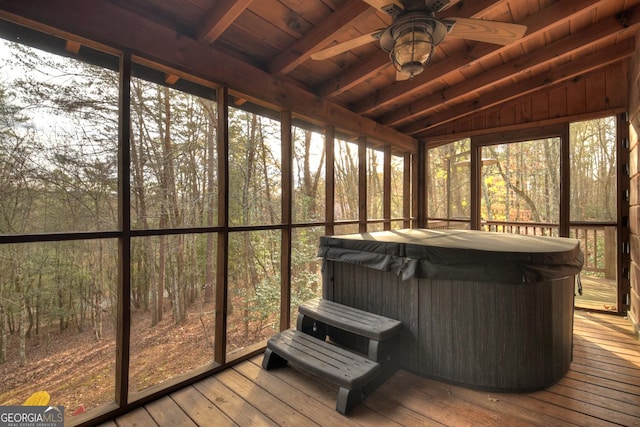 sunroom / solarium with vaulted ceiling with beams, a jacuzzi, ceiling fan, and wooden ceiling