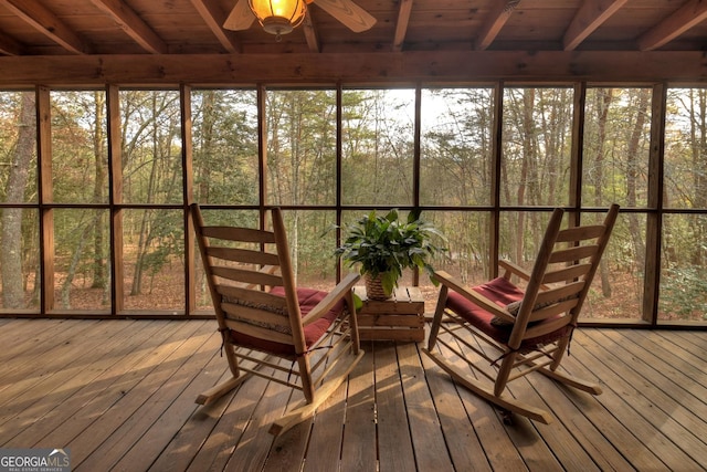 unfurnished sunroom featuring ceiling fan and wooden ceiling