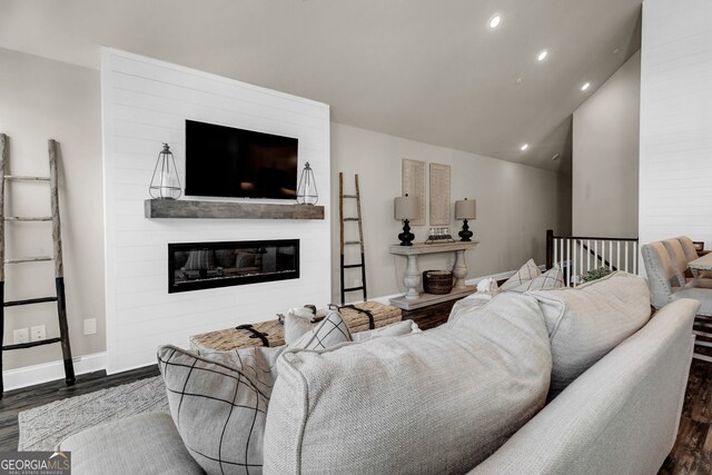 kitchen featuring white cabinets, appliances with stainless steel finishes, decorative light fixtures, sink, and a center island with sink