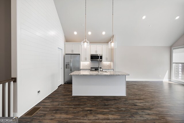 kitchen featuring light stone countertops, white cabinetry, and appliances with stainless steel finishes